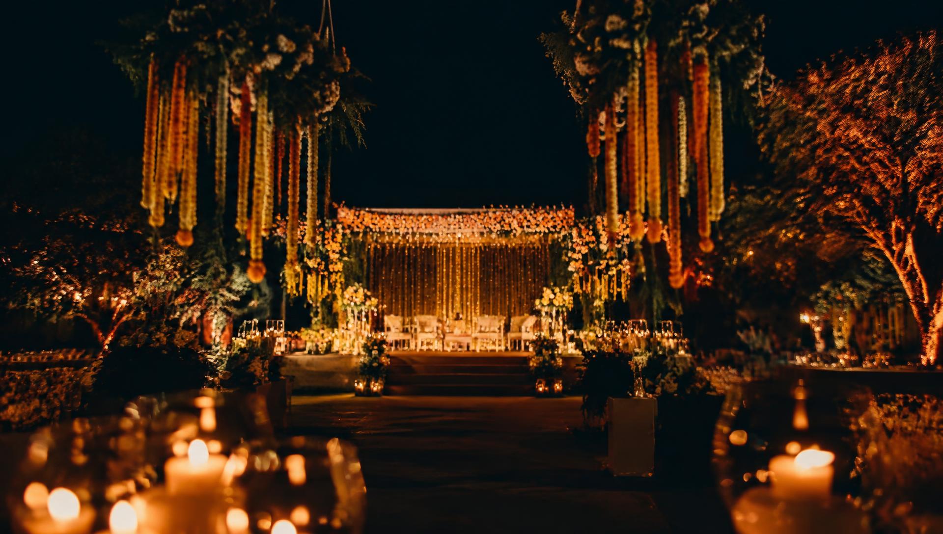 Elegant Indian wedding stage decorated with marigold garlands and warm lights